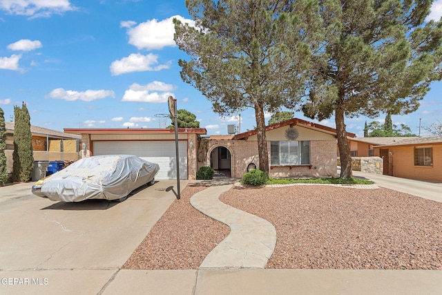 1664 Lou Graham Dr, El Paso, TX 79936 - view of front of house featuring brick siding, driveway, and a garage