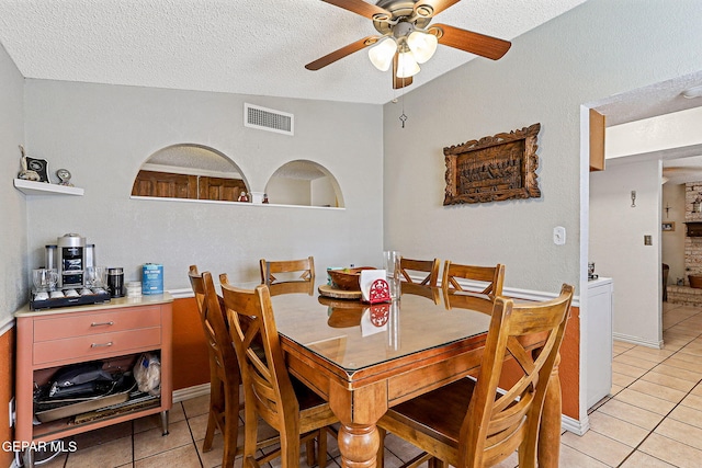 1664 Lou Graham Dr, El Paso, TX 79936 - dining area featuring light tile patterned flooring, ceiling fan, and a textured ceiling