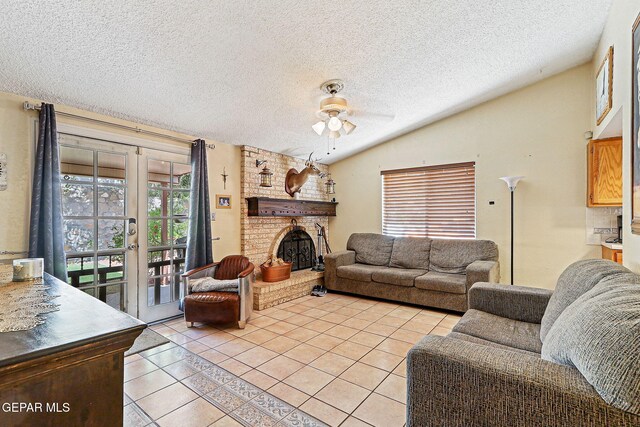 1664 Lou Graham Dr, El Paso, TX 79936 - living area with light tile patterned floors, a ceiling fan, a brick fireplace, vaulted ceiling, and a textured ceiling