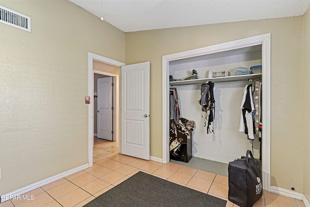 1664 Lou Graham Dr, El Paso, TX 79936 - bedroom featuring a closet, light tile patterned flooring, and baseboards