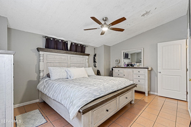 1664 Lou Graham Dr, El Paso, TX 79936 - bedroom with vaulted ceiling, light tile patterned floors, a textured ceiling, a ceiling fan, and baseboards