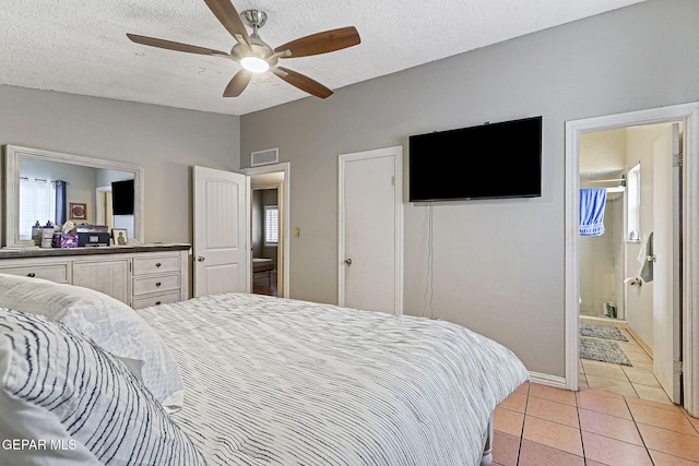 1664 Lou Graham Dr, El Paso, TX 79936 - bedroom with light tile patterned floors, a textured ceiling, baseboards, and ceiling fan