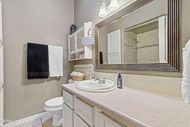 1664 Lou Graham Dr, El Paso, TX 79936 - full bath with toilet, backsplash, vanity, tile patterned flooring, and a shower