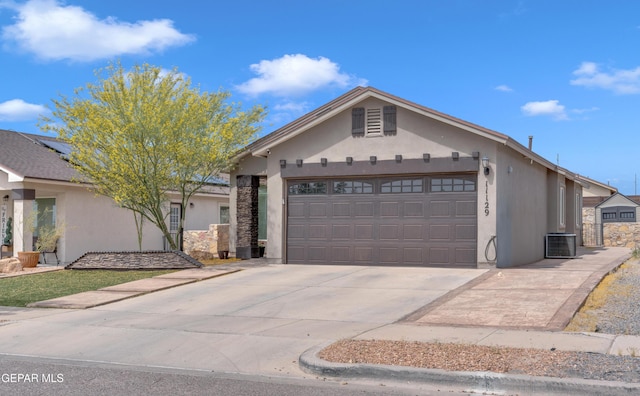 11129 Catherine Slutter Ln, Socorro, TX 79927 - ranch-style home featuring a garage, central AC, driveway, and stucco siding