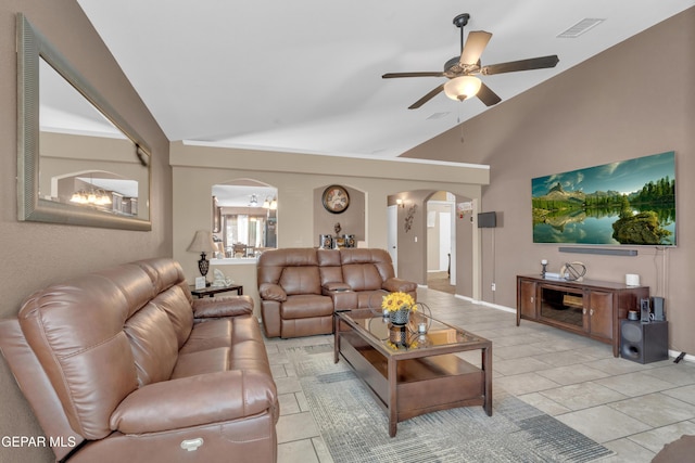 11129 Catherine Slutter Ln, Socorro, TX 79927 - living area with arched walkways, light tile patterned floors, ceiling fan, and high vaulted ceiling
