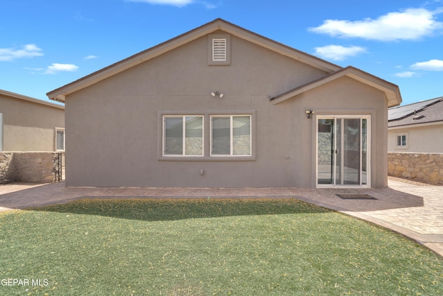 11129 Catherine Slutter Ln, Socorro, TX 79927 - back of house with stucco siding, a lawn, and a patio area