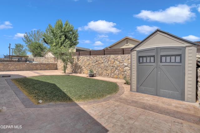 11129 Catherine Slutter Ln, Socorro, TX 79927 - view of yard with a storage unit, an outbuilding, and a patio