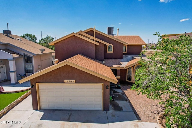 11968 Frances Scobee Dr, El Paso, TX 79936 - view of front facade with a garage, central AC, and stucco siding