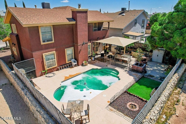 11968 Frances Scobee Dr, El Paso, TX 79936 - view of pool with a patio area, a fenced backyard, a shed, and an outbuilding