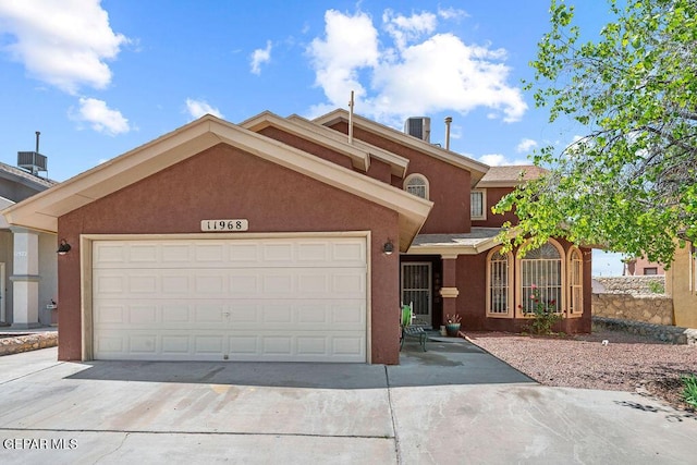 11968 Frances Scobee Dr, El Paso, TX 79936 - view of front of house with driveway, stucco siding, cooling unit, and a garage
