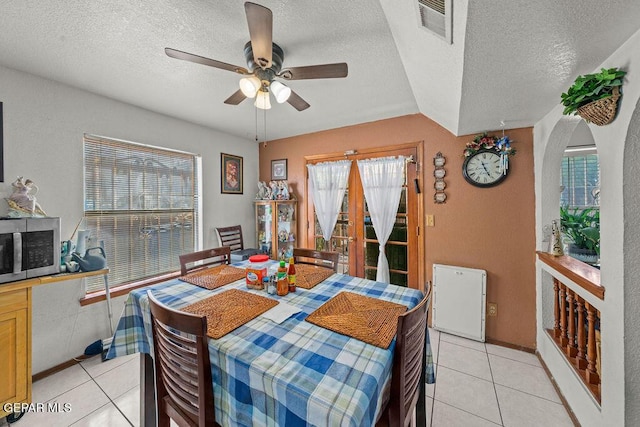 11968 Frances Scobee Dr, El Paso, TX 79936 - dining area featuring light tile patterned floors, a textured ceiling, ceiling fan, plenty of natural light, and arched walkways