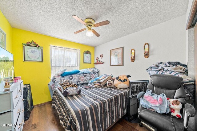11968 Frances Scobee Dr, El Paso, TX 79936 - bedroom with wood finished floors, a textured ceiling, and a ceiling fan