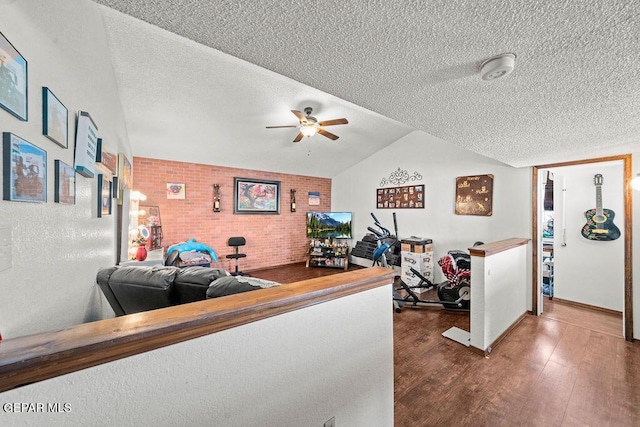 11968 Frances Scobee Dr, El Paso, TX 79936 - living area with ceiling fan, a textured ceiling, wood finished floors, lofted ceiling, and brick wall