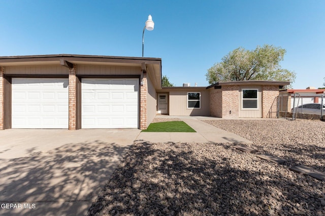 2912 Jarvis Dr, El Paso, TX 79935 - view of front of house with brick siding, concrete driveway, and a garage