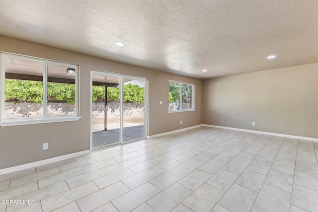 2912 Jarvis Dr, El Paso, TX 79935 - unfurnished room with a textured ceiling, recessed lighting, baseboards, and light tile patterned floors