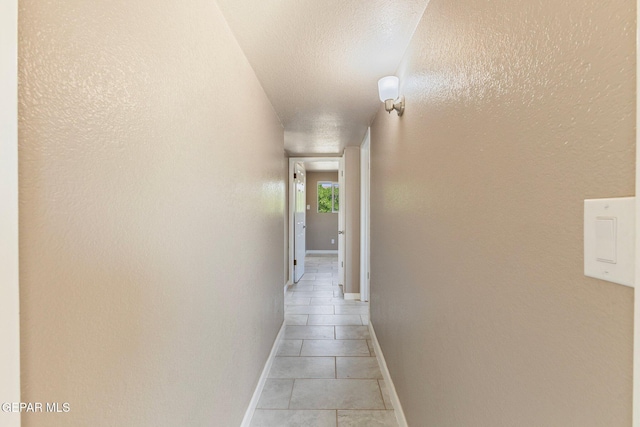 2912 Jarvis Dr, El Paso, TX 79935 - corridor featuring light tile patterned flooring and baseboards