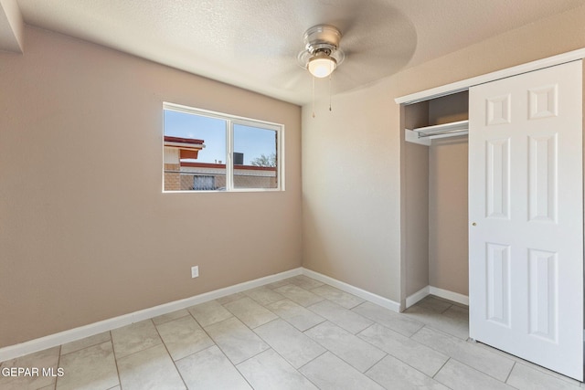 2912 Jarvis Dr, El Paso, TX 79935 - unfurnished bedroom with baseboards, a closet, light tile patterned flooring, and a ceiling fan