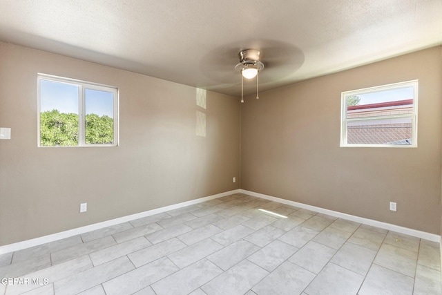 2912 Jarvis Dr, El Paso, TX 79935 - empty room with healthy amount of natural light, ceiling fan, baseboards, and light tile patterned floors