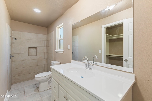 2912 Jarvis Dr, El Paso, TX 79935 - full bathroom featuring vanity, toilet, tile patterned flooring, and tiled shower