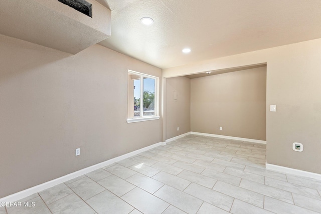 2912 Jarvis Dr, El Paso, TX 79935 - empty room featuring a textured ceiling, light tile patterned floors, recessed lighting, and baseboards