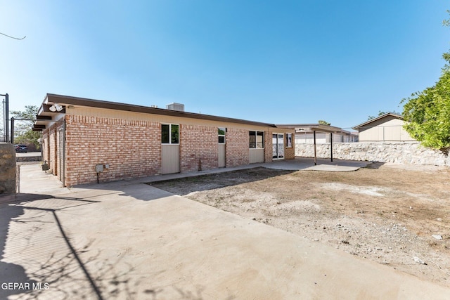 2912 Jarvis Dr, El Paso, TX 79935 - rear view of house featuring brick siding and a patio area