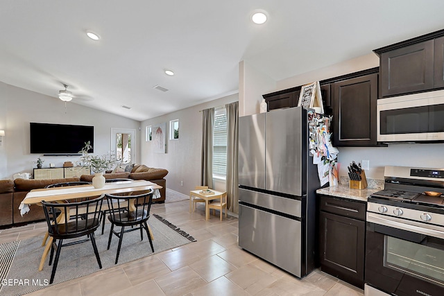 436 Sun Temple Rd, Socorro, TX 79927 - kitchen with appliances with stainless steel finishes, open floor plan, lofted ceiling, dark brown cabinets, and light stone counters