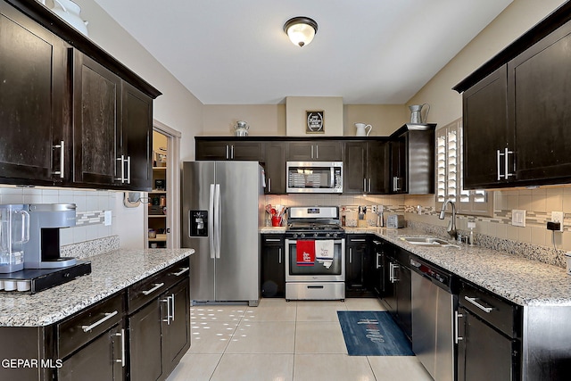 2005 Roy Vinson, El Paso, TX 79938 - kitchen featuring stainless steel appliances, a sink, decorative backsplash, and light stone countertops
