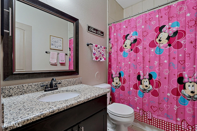 2005 Roy Vinson, El Paso, TX 79938 - full bath with vanity, toilet, a shower with curtain, and a textured wall