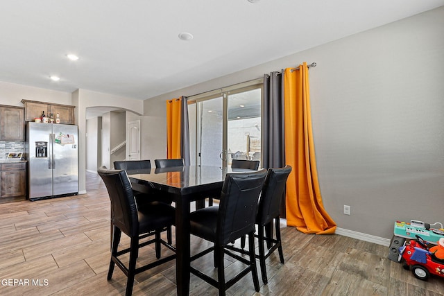 2808 Tierra De Moyo Pl, El Paso, TX 79938 - dining area featuring arched walkways, light wood-style floors, and baseboards