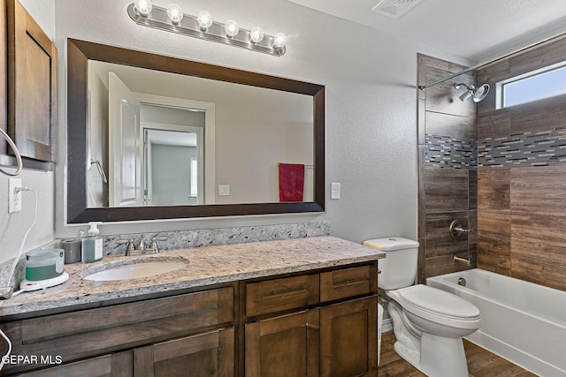 2808 Tierra De Moyo Pl, El Paso, TX 79938 - full bath with vanity, toilet, wood finished floors,  shower combination, and a textured wall