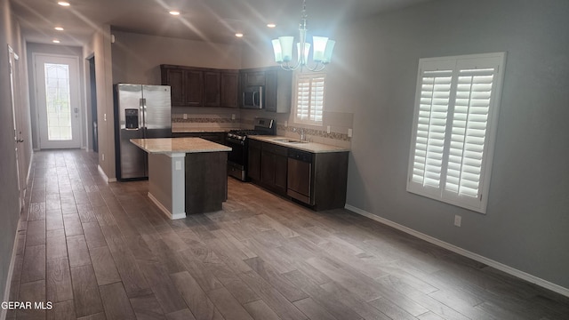 12869 Woolstone Dr, El Paso, TX 79928 - kitchen with stainless steel appliances, plenty of natural light, wood finished floors, a chandelier, and recessed lighting