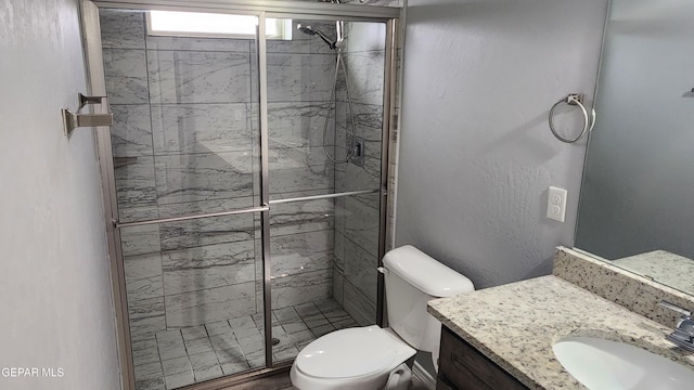 12869 Woolstone Dr, El Paso, TX 79928 - bathroom featuring a stall shower, toilet, and vanity