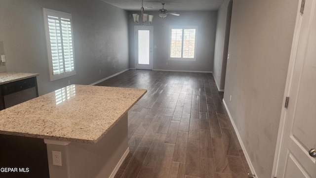 12869 Woolstone Dr, El Paso, TX 79928 - unfurnished dining area featuring dark wood-type flooring, baseboards, and a chandelier