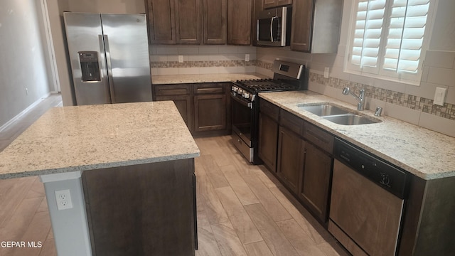 12869 Woolstone Dr, El Paso, TX 79928 - kitchen with stainless steel appliances, a sink, a center island, backsplash, and dark brown cabinets