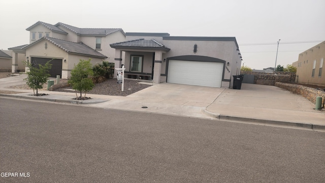 12869 Woolstone Dr, El Paso, TX 79928 - view of front of house featuring concrete driveway, stucco siding, a garage, and a tiled roof