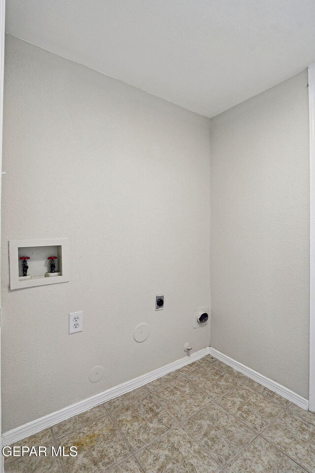 clothes washing area with gas dryer hookup, electric dryer hookup, washer hookup, and baseboards