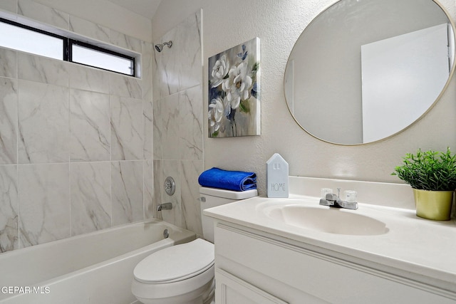 full bath featuring shower / bathtub combination, toilet, vanity, and a textured wall