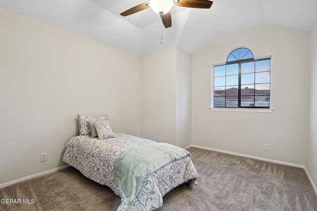 bedroom featuring carpet, vaulted ceiling, baseboards, and ceiling fan