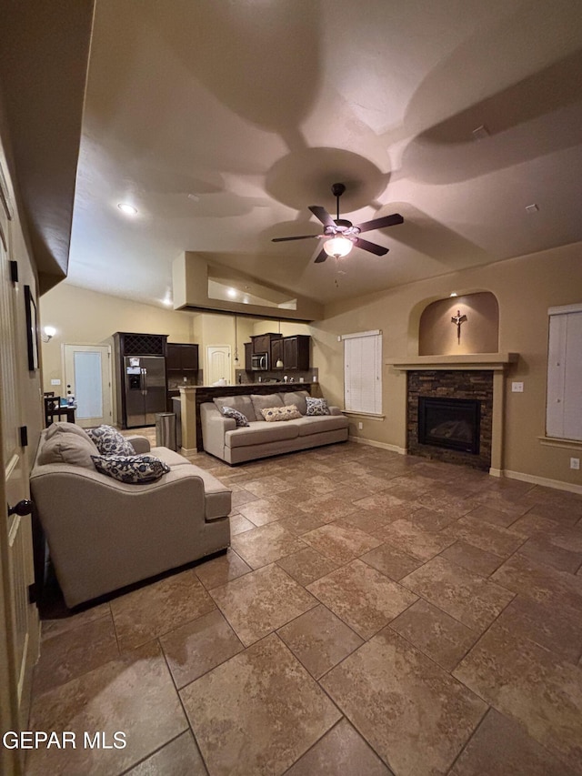 14215 Rattler Point Dr, El Paso, TX 79938 - living area with baseboards, stone tile flooring, a ceiling fan, and a fireplace