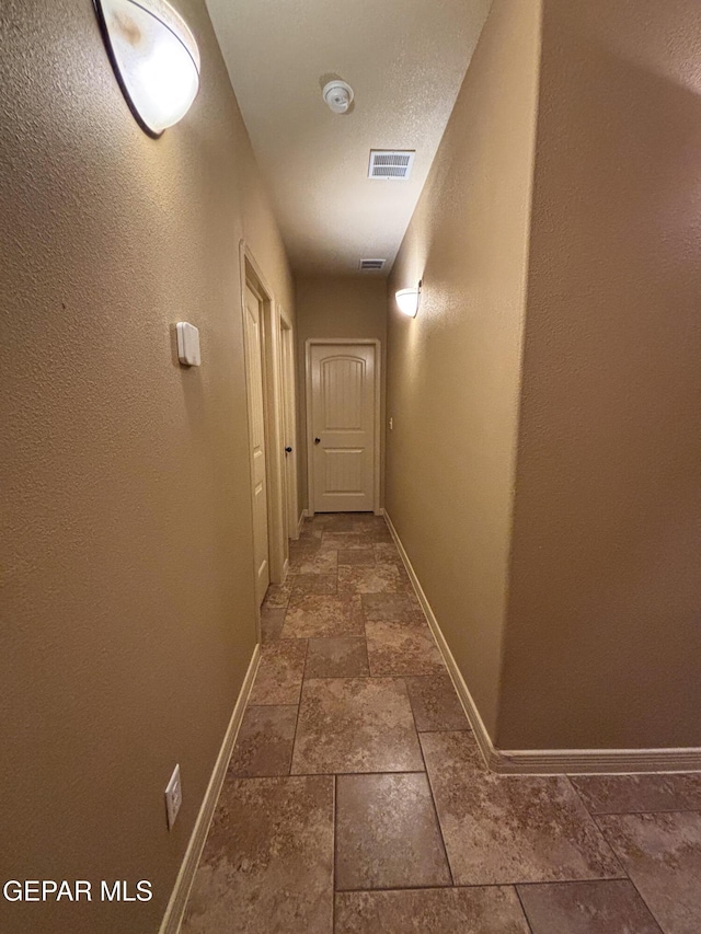 14215 Rattler Point Dr, El Paso, TX 79938 - corridor featuring stone tile floors and baseboards