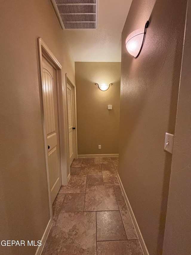 14215 Rattler Point Dr, El Paso, TX 79938 - corridor featuring stone tile flooring and baseboards