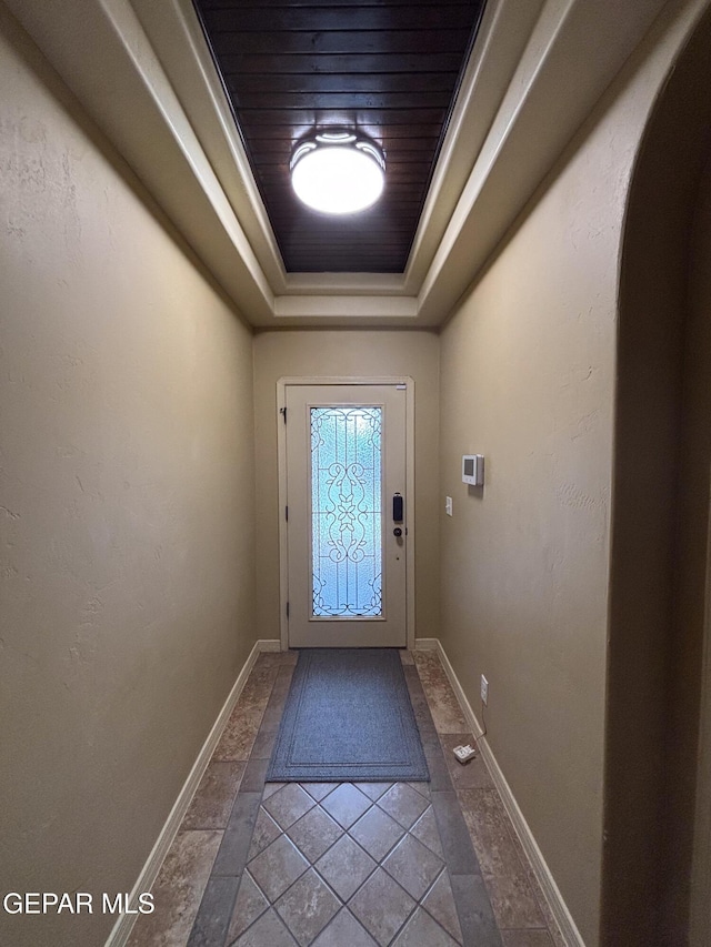 14215 Rattler Point Dr, El Paso, TX 79938 - entryway with a tray ceiling, baseboards, and arched walkways
