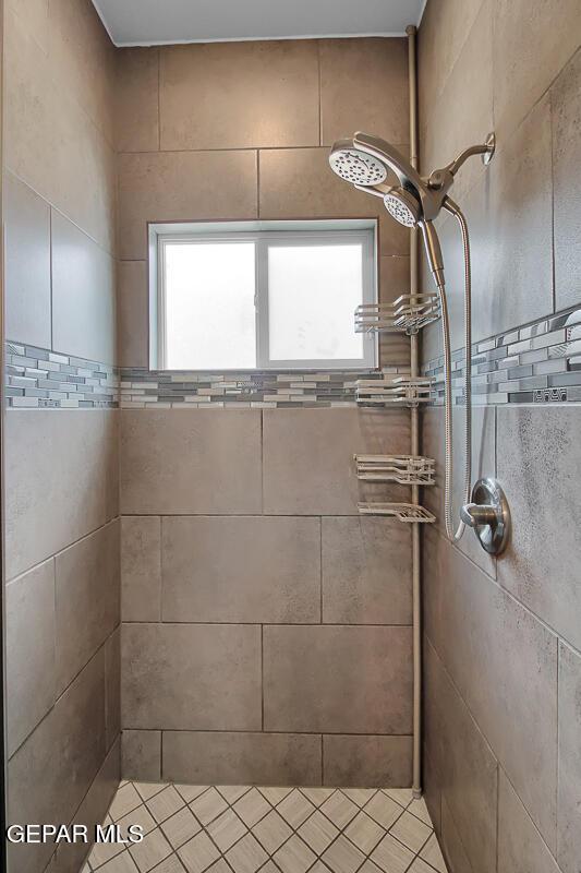 full bath with a tile shower