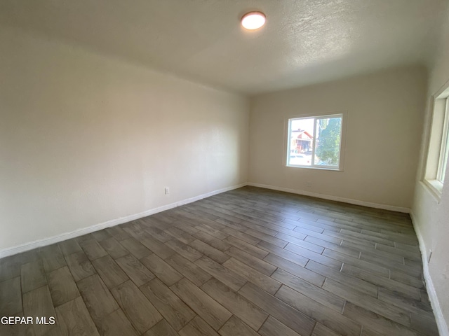 2805 Grant Ave, El Paso, TX 79930 - spare room featuring wood finish floors, baseboards, and a textured ceiling