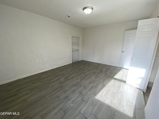 2805 Grant Ave, El Paso, TX 79930 - unfurnished bedroom with dark wood-style flooring, baseboards, and a closet