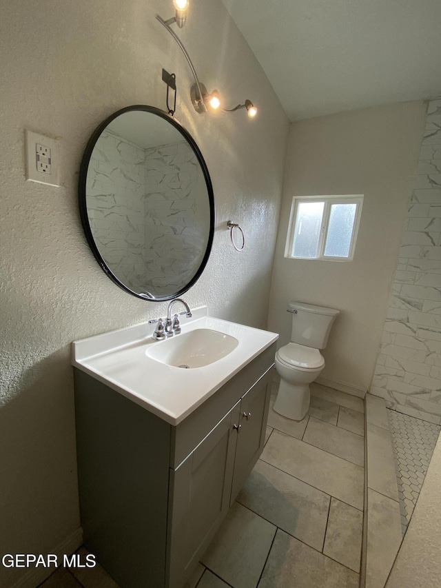2805 Grant Ave, El Paso, TX 79930 - bathroom with vanity, toilet, and a textured wall