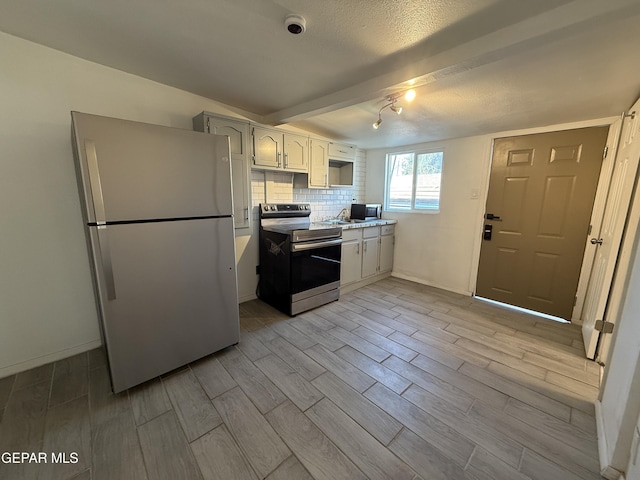 2805 Grant Ave, El Paso, TX 79930 - kitchen with appliances with stainless steel finishes, wood finish floors, light countertops, backsplash, and baseboards