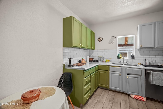 2805 Grant Ave, El Paso, TX 79930 - kitchen featuring a sink, dishwasher, green cabinets, light countertops, and a textured ceiling