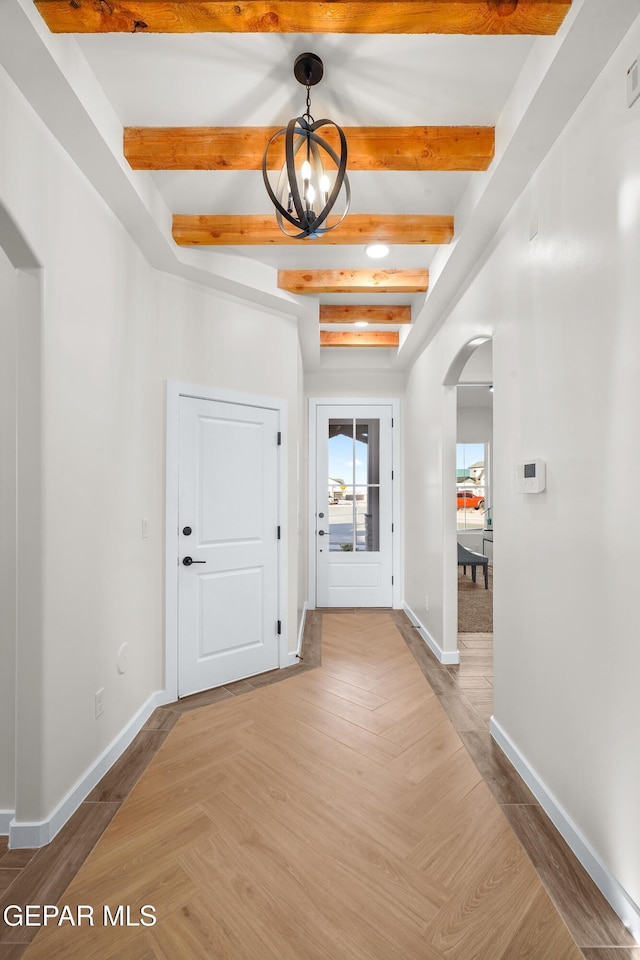 3829 Aspire Pl, El Paso, TX 79938 - foyer with arched walkways, a chandelier, beam ceiling, and baseboards