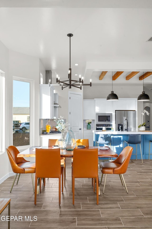 3829 Aspire Pl, El Paso, TX 79938 - dining area featuring wood finish floors, a chandelier, and beam ceiling